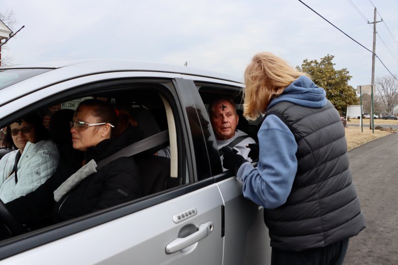 Getting ashes from Pastor Pat Bollinger is a family affair for the Berry family from Milton.